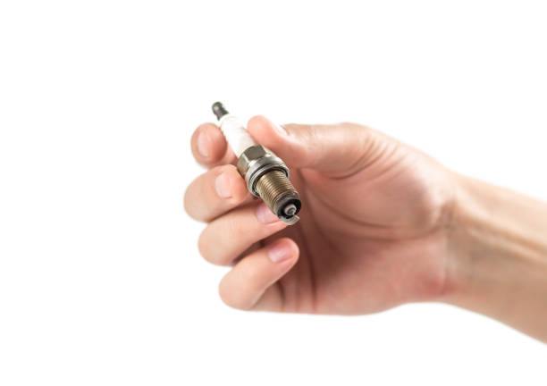 istock The hand holds an old iridium spark plug. Close up. Isolated on a white background 1403929619