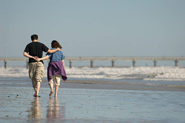 Couple Alone Walking on Beach stock photo