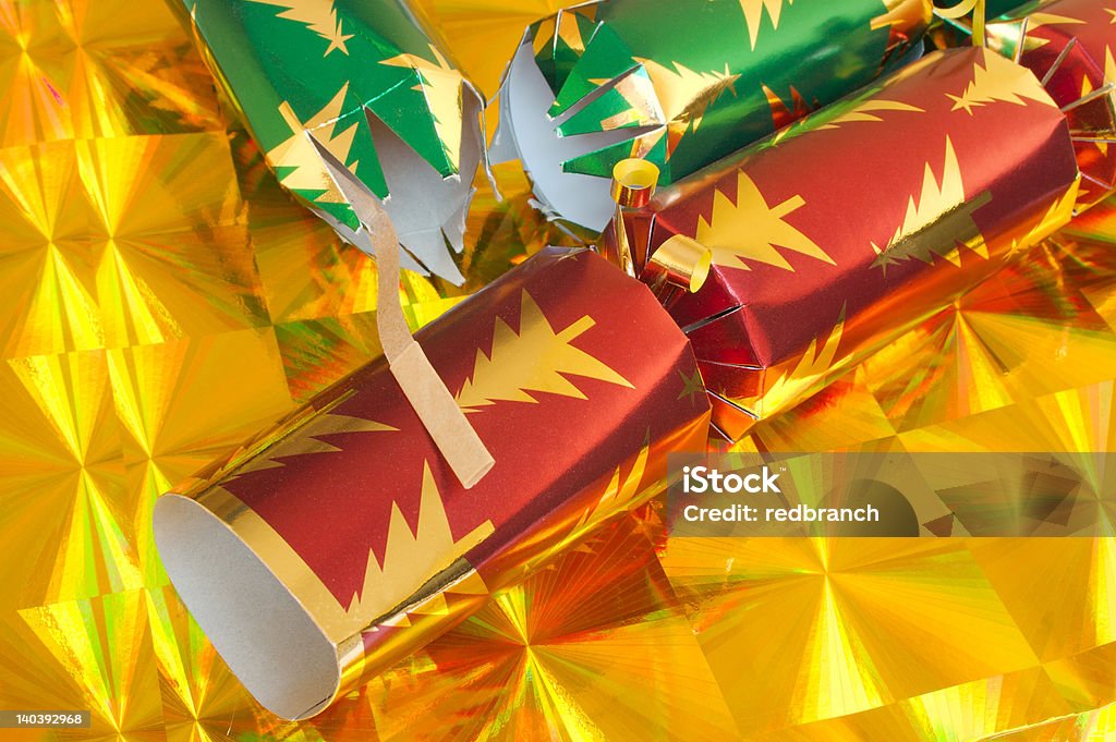 Party Crackers Two Christmas Crackers on a yellow party background. One of the Crackers has been pulled. Celebration Stock Photo