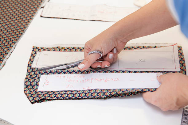 istock Tailor. Woman Hands notch tailor tailor's scissors cloth. Close Up. 1403934686
