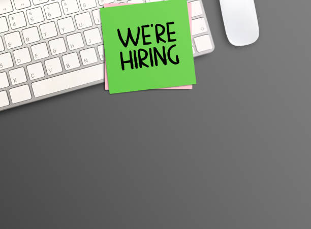 istock Top view with we're hiring text and keyboard on black table background. 1403937548