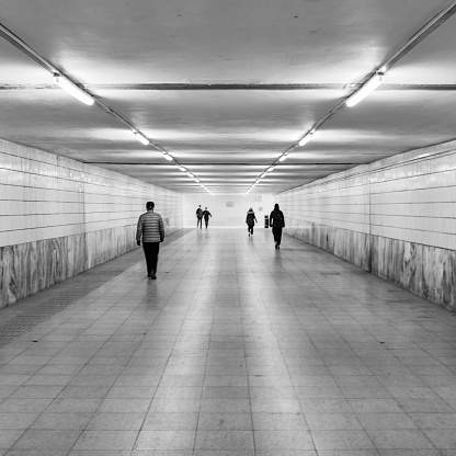 In March 2022, people walk through an underground passage in winter. The location is on the South Road of the West Third Ring Road in Beijing.