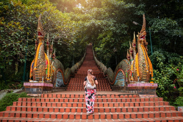 young woman walking up the stairs of the temple, doi suthep in chiang mai, thailand. - suthep imagens e fotografias de stock