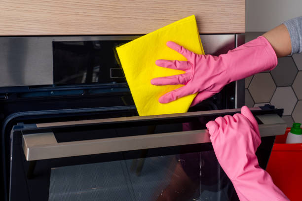 istock Young woman cleaning oven in the kitchen 1403940516