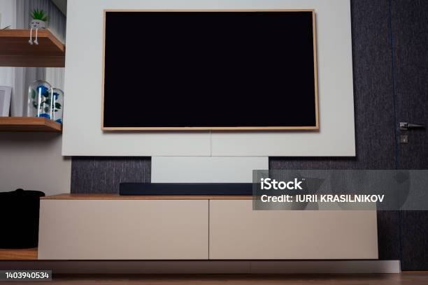 Modern Living Room With Wood Floor And Home Movie Theater Blurred Background Stock Photo - Download Image Now