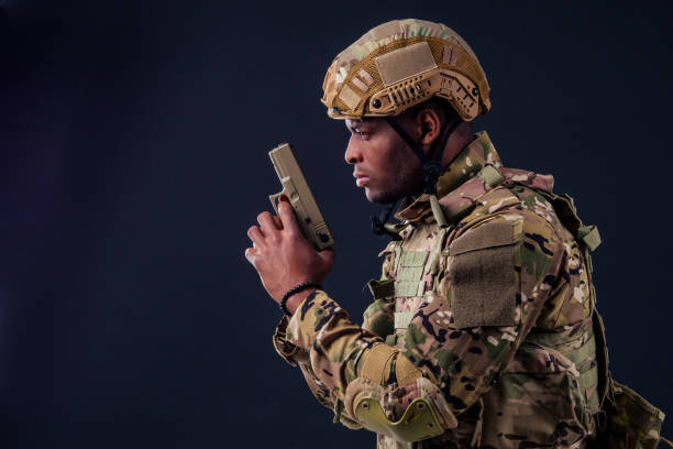 istock american man in camouflage suit aiming with a pistol 1403940653