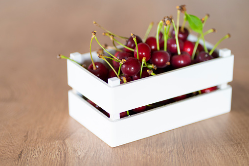 Cherries in white wooden crate