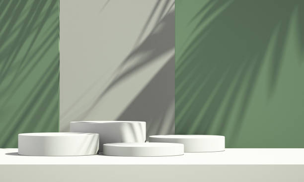 istock 3D green product podium display with green and white background and tree shadow,summer product mockup background,3D render illustration 1403943149