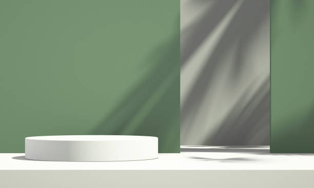 istock 3D green product podium display with green and white background and tree shadow,summer product mockup background,3D render illustration 1403943164