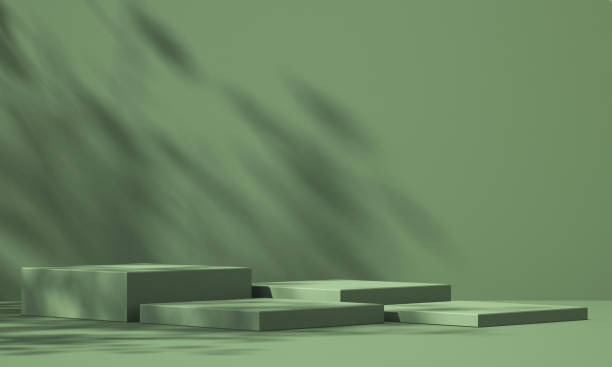 istock 3D green product podium display with green background and tree shadow,summer product mockup background,3D render illustration 1403943190
