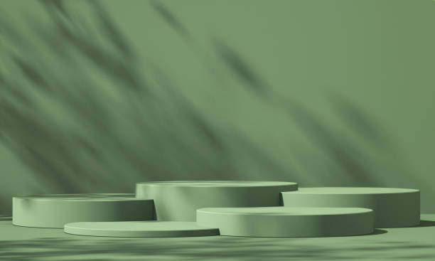 istock 3D green product podium display with green background and tree shadow,summer product mockup background,3D render illustration 1403943192