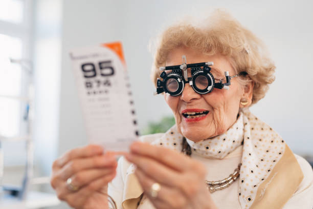 istock senior woman checking eyesight in clinic 1403945737