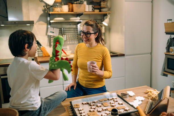 istock mother and son preparing cookies in home kitchen 1403945874