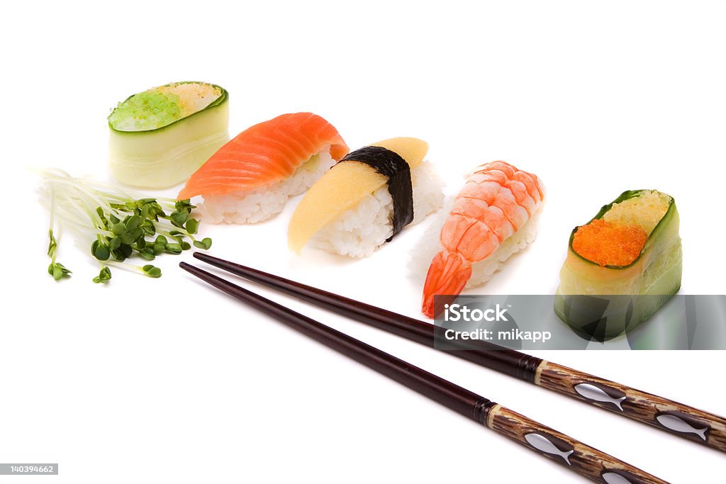 Sushi and chopsticks Fresh sushi, chopsticks and green on white background Algae Stock Photo