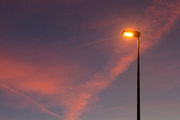 istock Street light silhouette and sunset cloudscape background. 1403946730