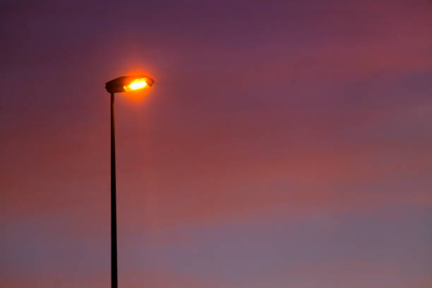 istock Street light silhouette and sunset cloudscape background. 1403946756