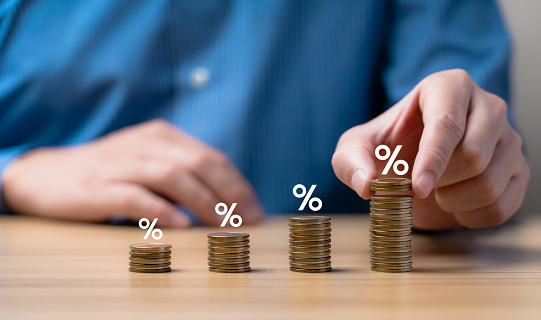 Interest rate and dividend concept. Businessman is calculating income and return on investment as a percentage. Show returns from mutual funds and stocks. long term investment for retirement