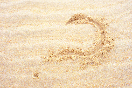 Letter J. English Handwritten Alphabet In The Sand.