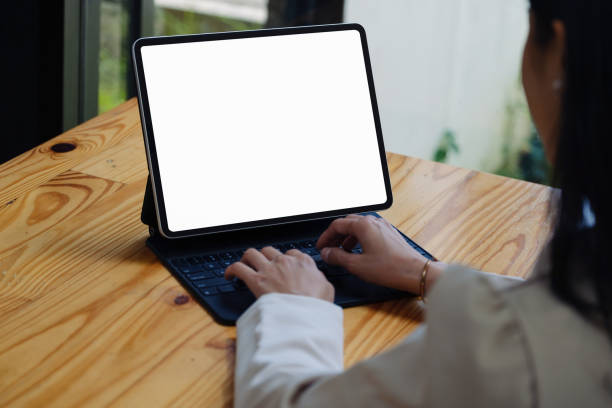 istock A woman using a tablet with a blank white screen. The blank space on the white screen can be used to write a message or place an image 1403948336