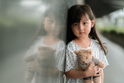 Portraits sad Toddler girl holding teddy bear