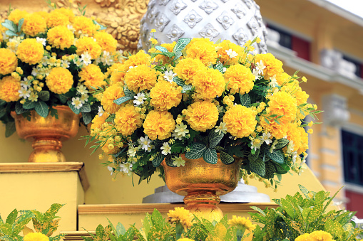 Close up artificial craft product of yellow rose arrangement in Buddhist Temple