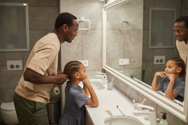 istock Black Father Braiding Hair 1403951693