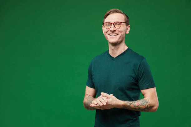 presentatore sorridente su green - green t shirt foto e immagini stock