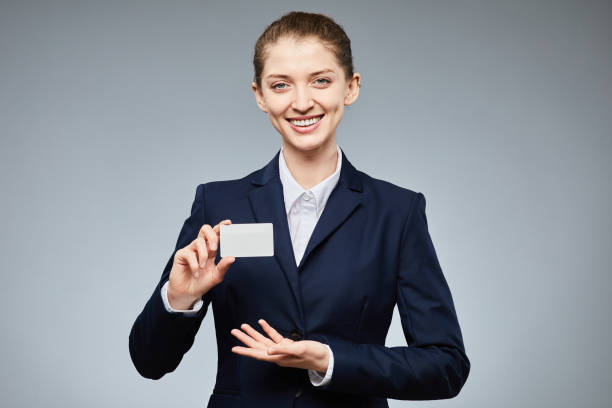 istock Smiling Woman Presenting Business Card 1403952411