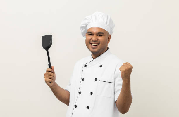 istock Young handsome asian man chef in uniform standing with turner kitchen utensils various gesture action on isolated background. Cooking man Occupation chef People in kitchen restaurant and hotel. 1403954230