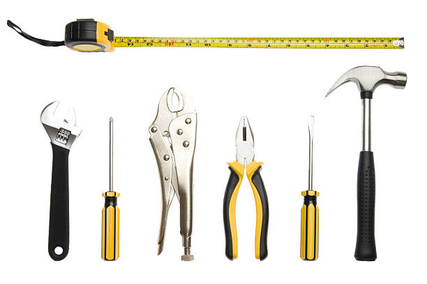 Seven black and yellow tools on a white background stock photo