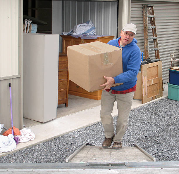 Man loads a moving van stock photo