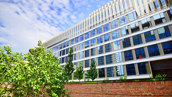 Wide angle view of modern corporate building with greenery.