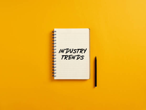 istock Notepad and black pen on yellow background with the word industry trends. 1403957280