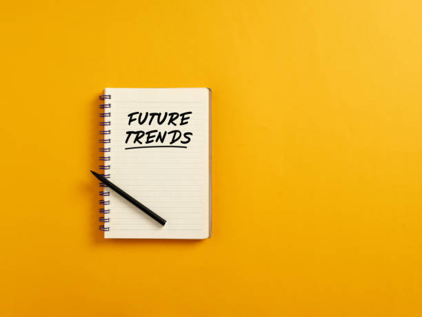 istock Notepad and black pen on yellow background with the word future trends. 1403958163