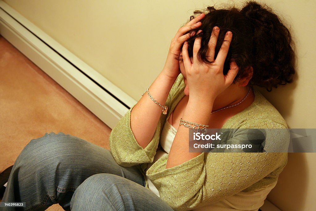 Teenager with Depression Young Teen holding Head with a Case of Depression Adolescence Stock Photo