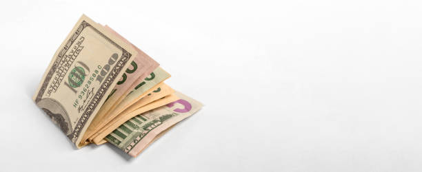American dollars of different denominations folded in half on a white background.