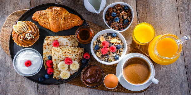 istock Breakfast served with coffee, juice, pancakes and croissants 1403963523