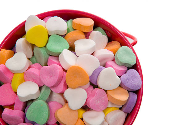Bucket of Candy Valentine's Hearts - Close-up Bucket full of candy hearts in assorted colors for Valentine's Day circa 14th century photos stock pictures, royalty-free photos & images