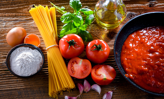 Composition with dried spaghetti, and pasta ingredients.