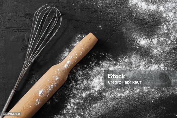 Scattered Flour With Rolling Pin On Black Background Stock Photo - Download Image Now