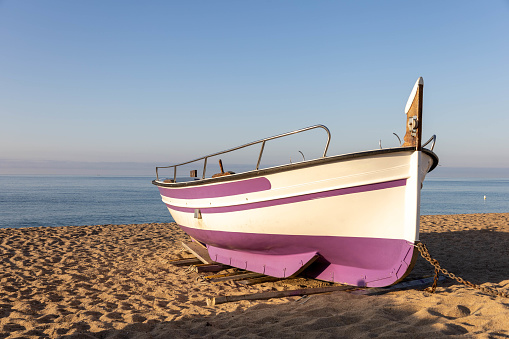 Fishing boat on the beach in Pineda de Mar, Costa Brava, Spain