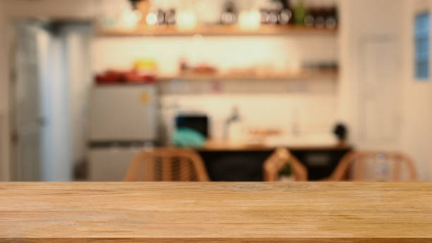 istock Wooden table against blurred modern kitchen in background. Copy space for display or montage your products. 1403965139