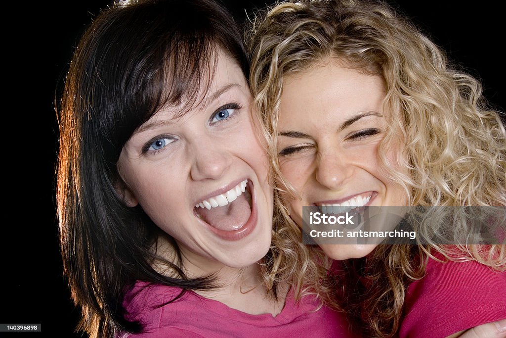 Laughing out loud Two pretty female friends laughing out loud Adult Stock Photo