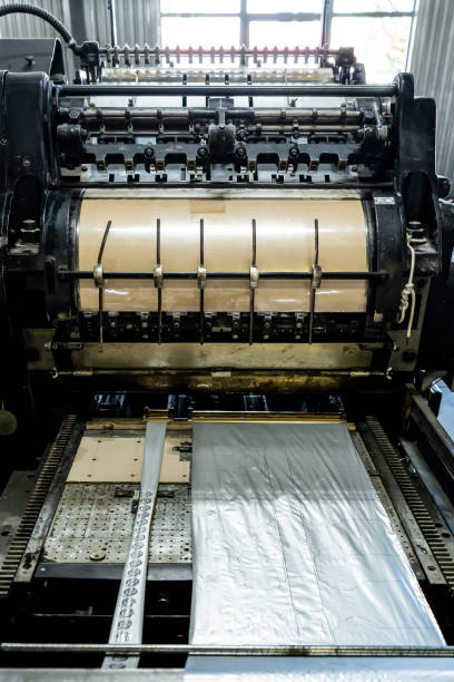 istock Offset printing machine feeder transfer metallic paper through the feeding table to the printing unit 1403969294