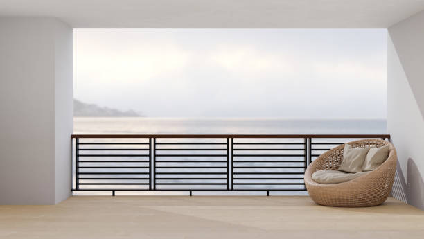 istock Modern luxury spacious balcony interior design with comfy wicker lounge armchair 1403972408