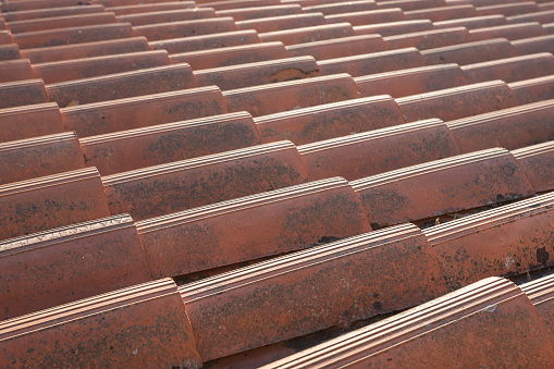Close up of the red clay roof tiles. Background of old roof.