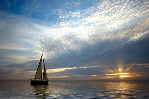 sailing and sunset stock photo