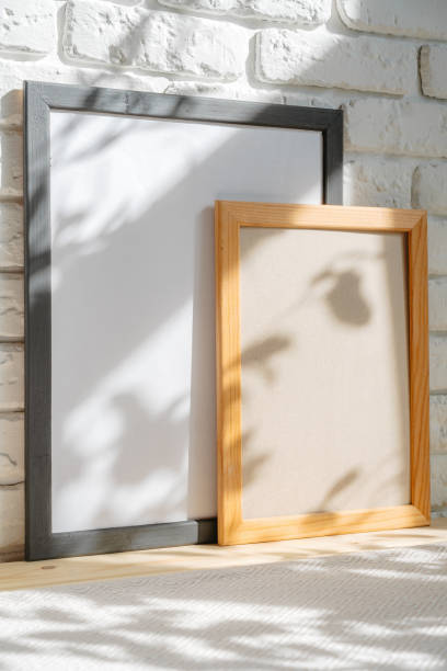 istock Photo frames on floor over white brick wall 1403973588