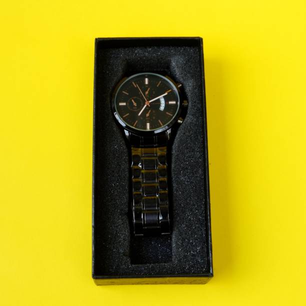 istock watch, with black cardboard isolated on yellow background 1403975348