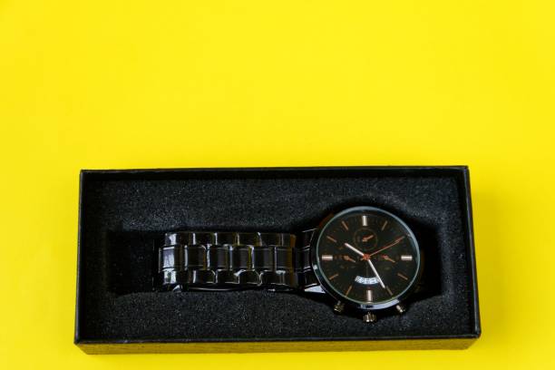 istock watch, with black cardboard isolated on yellow background 1403975368
